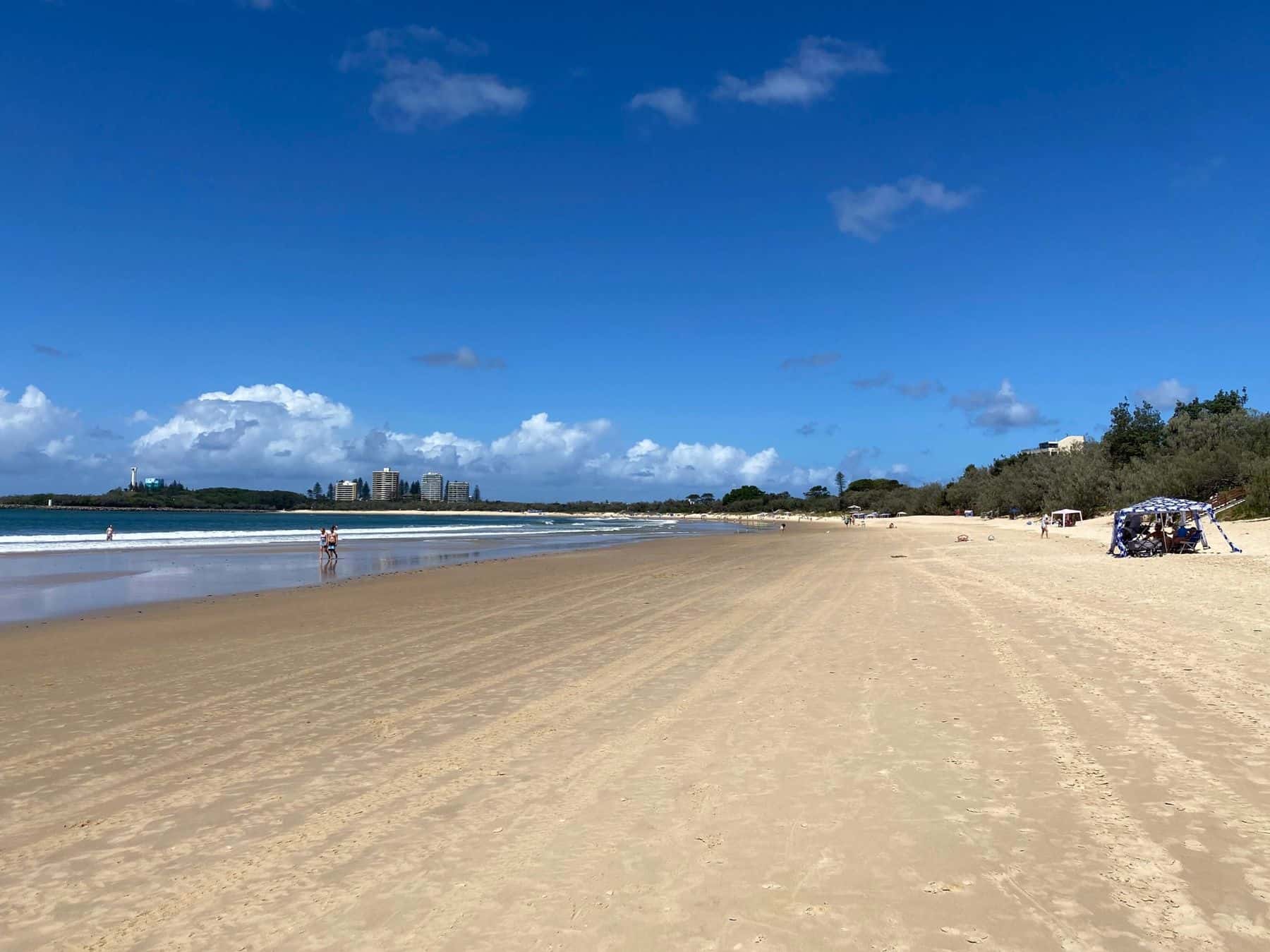 Wide sandy Mooloolaba beach on the Sunshine Coast under a blue sky